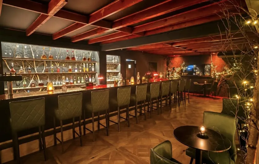 Warm wood and black leather chairs at the bar.