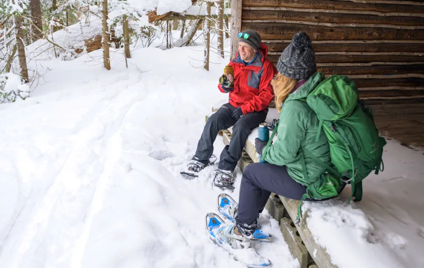 Snowshoers rest in a lean-to at Paul Smith's VIC on a snowy winter day