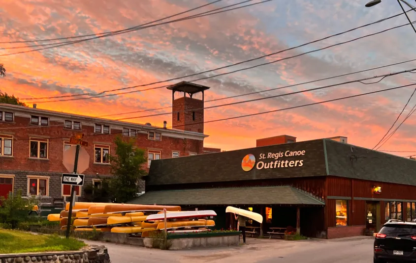 Gorgeous pink and orange sunset over St Regis Canoe Outfitters shop.