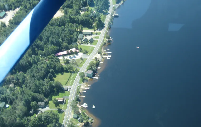An aerial view of a road along the lake.