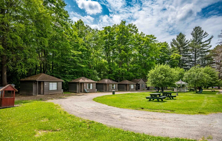 A round driveway to the small brown cabins.