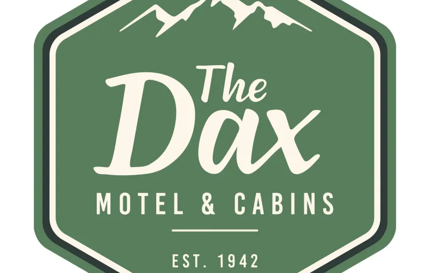 A green hexagon badge with white lettering for The Dax Motel & Cabins EST 1942.