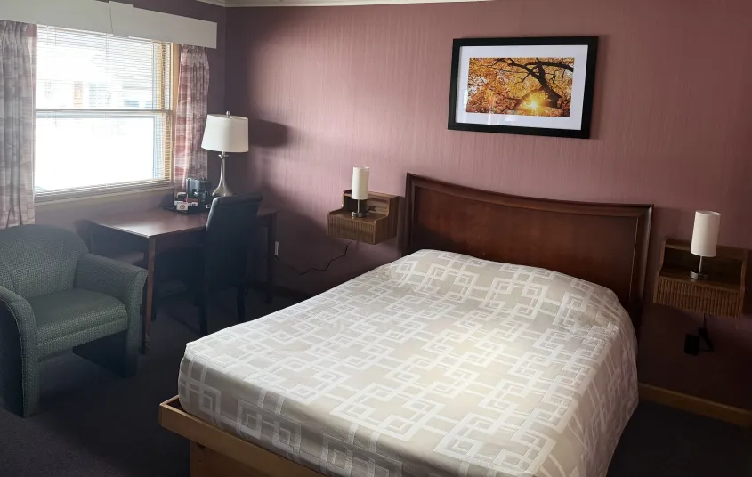 microwave and dresser and walls of knotty pine paneling at the Tupper Lake Motel