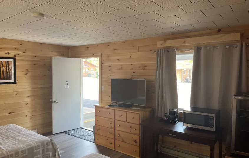 Facing the tv and window in a room.