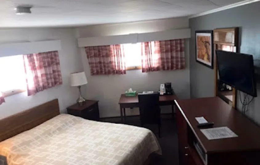 A high angle view of a room with desk and multiple windows.