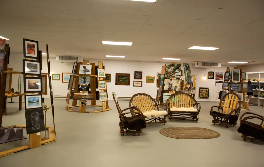 Man looks at art on display at the Tupper Arts Center