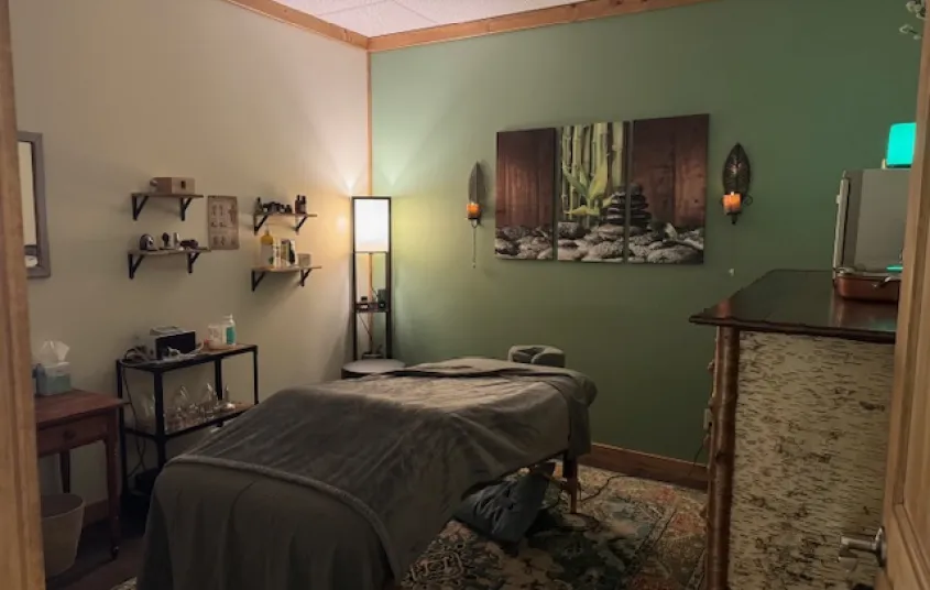 Treatment room with relaxing mint walls and soft lighting.