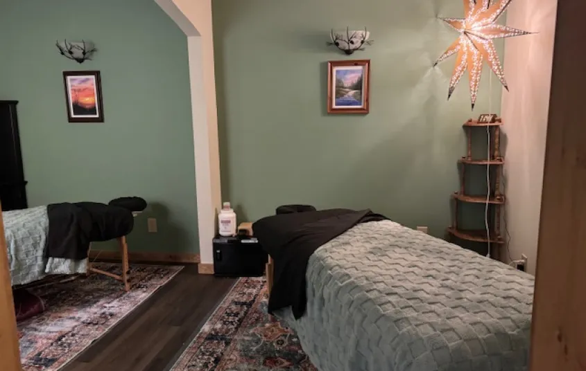 Treatment room with relaxing mint walls and soft lighting.