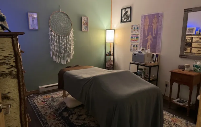Treatment room with relaxing mint walls and soft lighting.