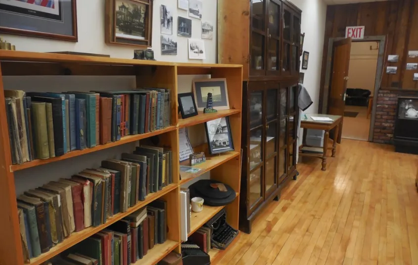 Shelves of books and displays on the wall.