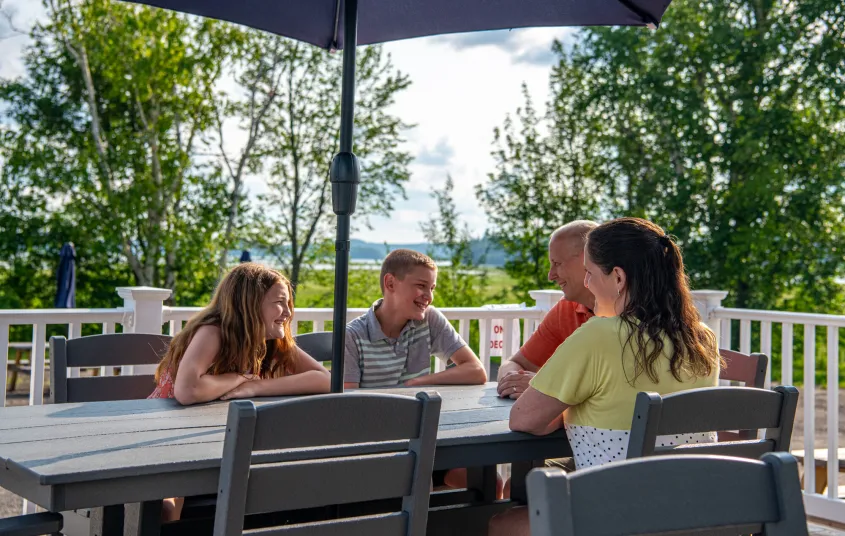 People sit around an outdoor table.