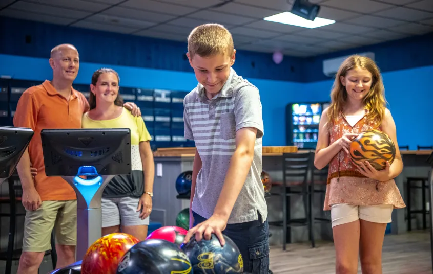 A boy selects the perfect bowling ball.