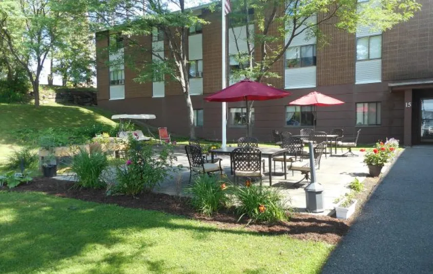 Patio area by grass at a brick complex