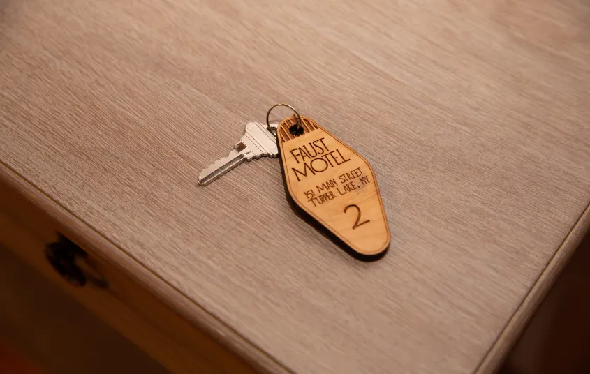 A key on a charm for room 2 at The Faust Motel.
