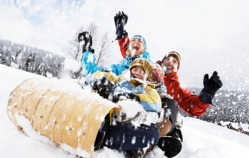 A happy family on a toboggan