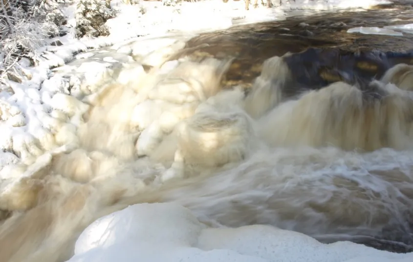 A close up of a waterfall in the winter