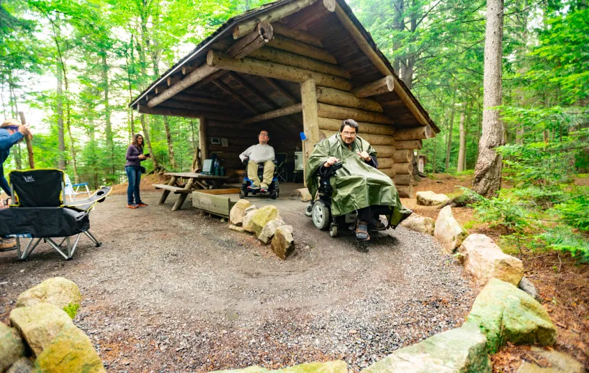 Two people at an accessible lean-to