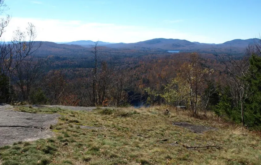 A hazy view of mountains from a summit