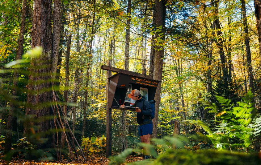 A hiker signing into the register for a mountain