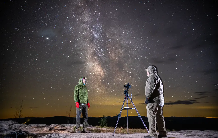 A couple people stargazing on Coney Mountain's bald summit