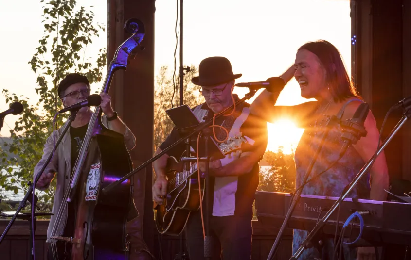 band sings as the sun sets at the bandshell in Tupper Lake