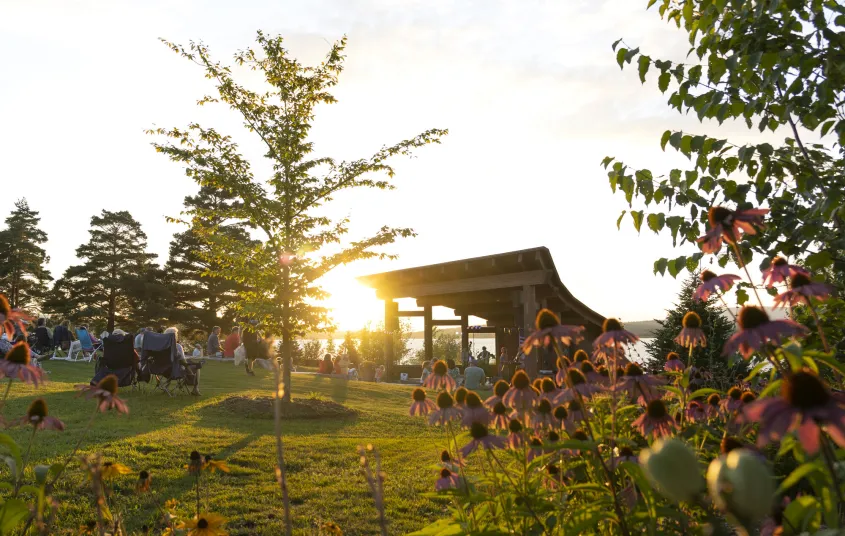 Crowd enjoys live music from the sunset stage bandshell as the sun sets