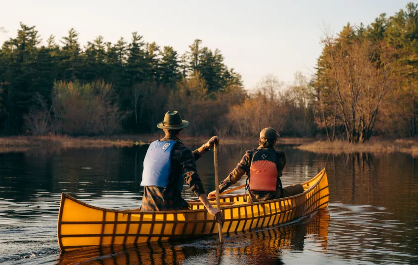 A pack boat with two people on a river