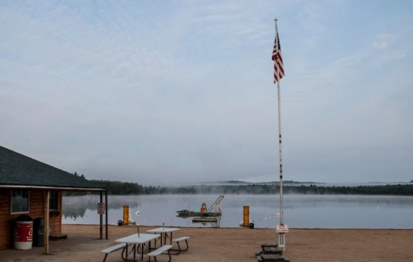 A beach with a building and American flag