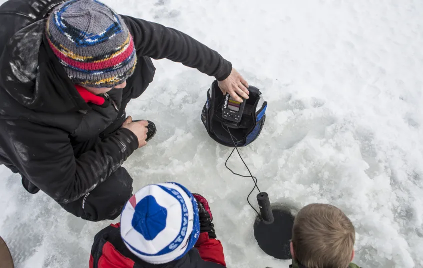 A family ice fishes