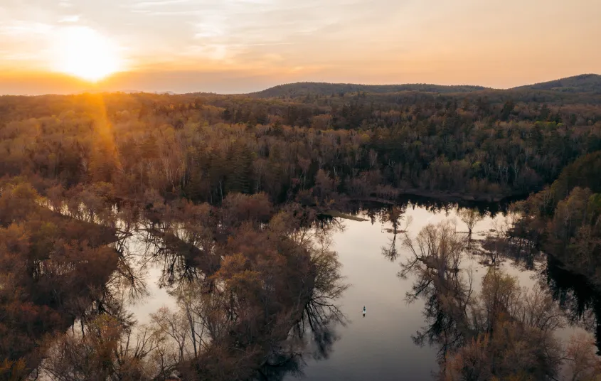 Aerial photo of a winding waterway at sunset