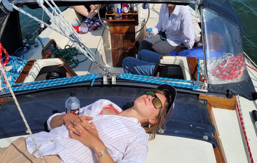 Person relaxing on sailboat