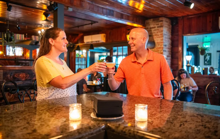 a couple cheering drinks