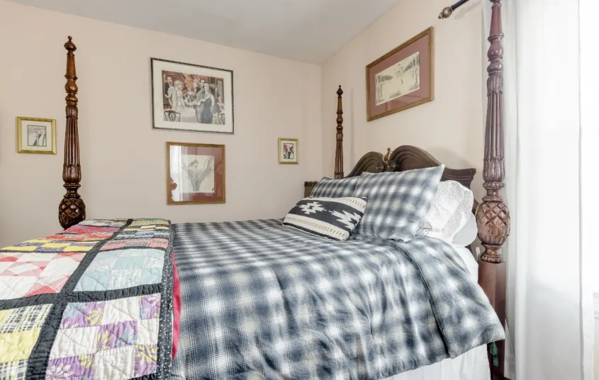 A guest room with a four post bed