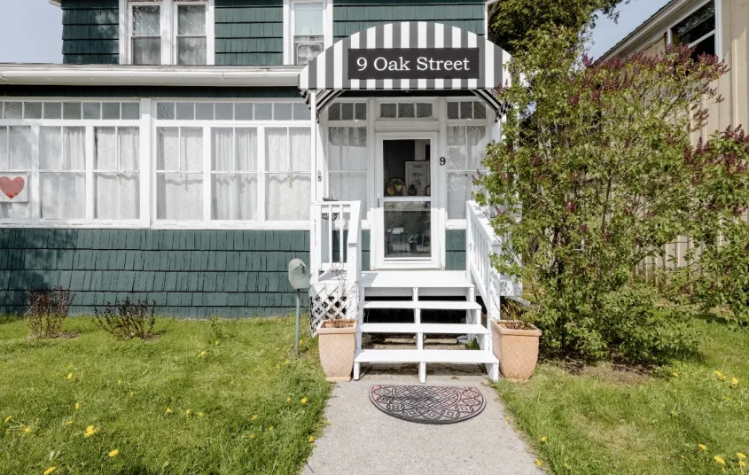 The formal dining space with comfy chairs and salmon walls