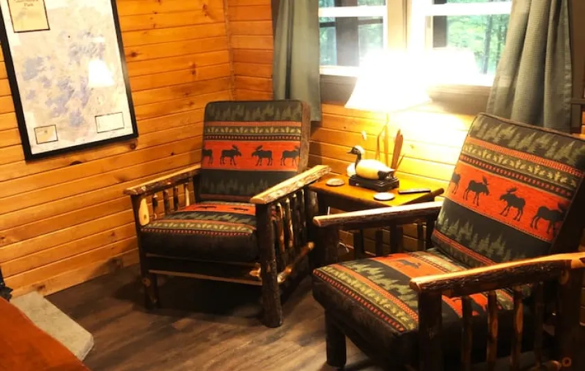 The living space with two rustic armchairs at Rockledge Cabins & Retreats 