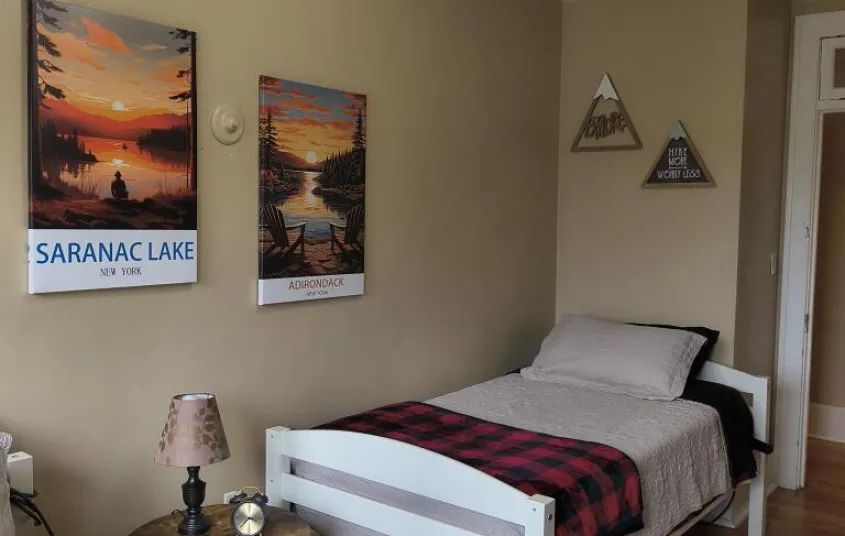  wooden headboard and a wooden arrow decor on the wall.