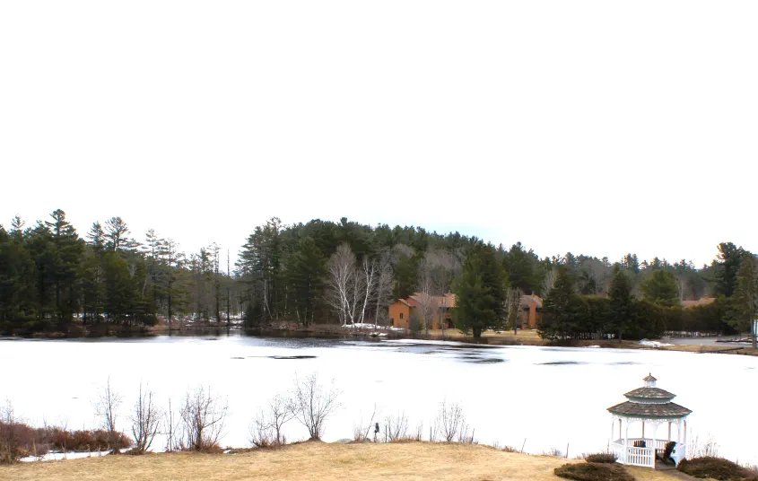 The snow covered pond by Sara Placid Inn & Suites.
