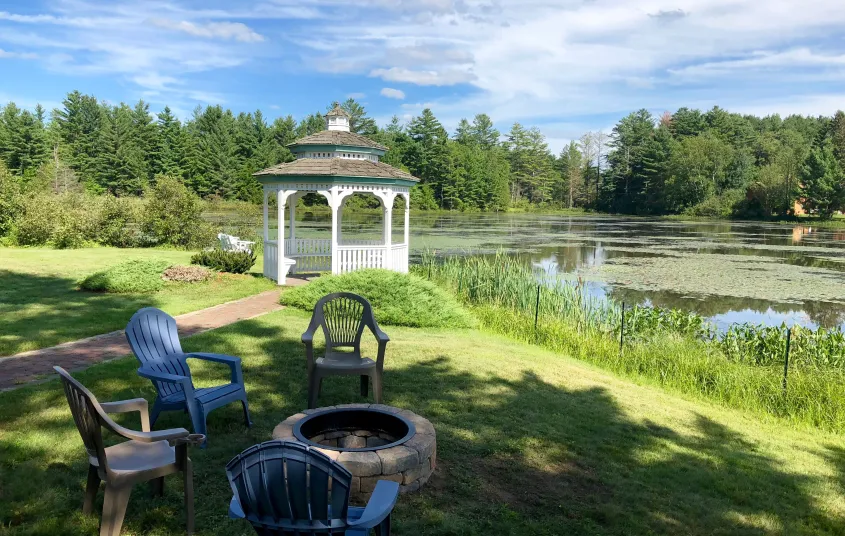 The white gazebo by the water at Sara Placid Inn & Suites.