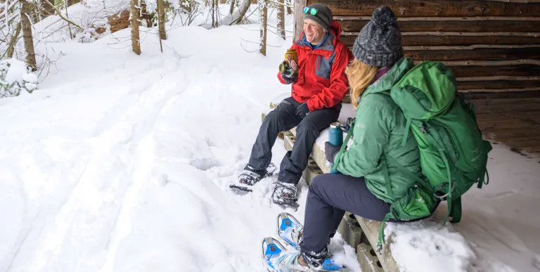 Snowshoers rest in a lean-to at Paul Smith's VIC on a snowy winter day