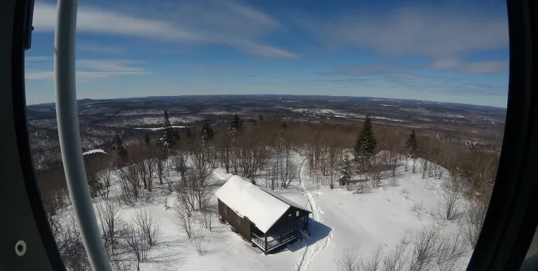 A view of an old firetower observers cabin in the winter