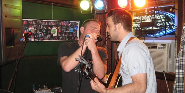 Band performing with singer and guitar.