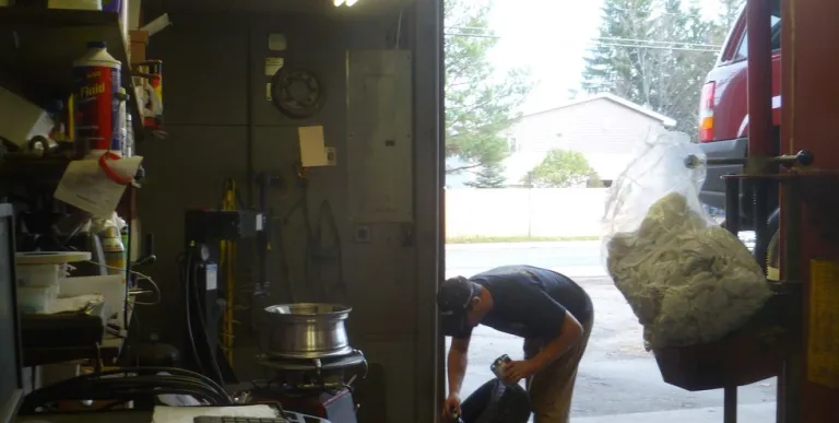 A person moves a tire at Counters Garage and towing.