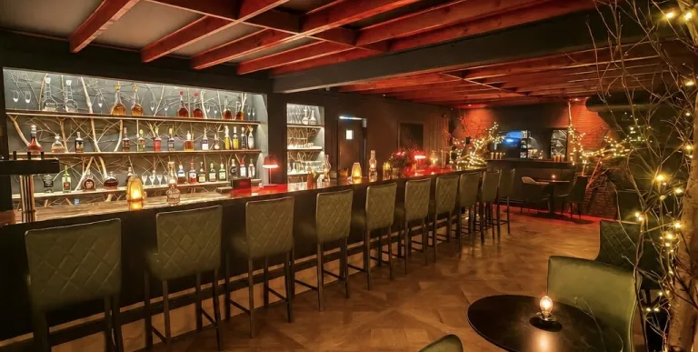 Warm wood and black leather chairs at the bar.
