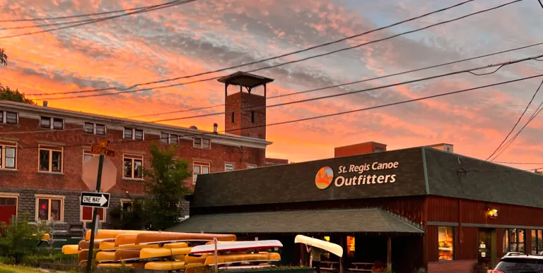 Gorgeous pink and orange sunset over St Regis Canoe Outfitters shop.