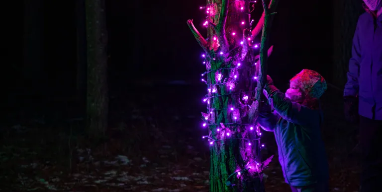 A family gazes out at the water from a large waterside structure