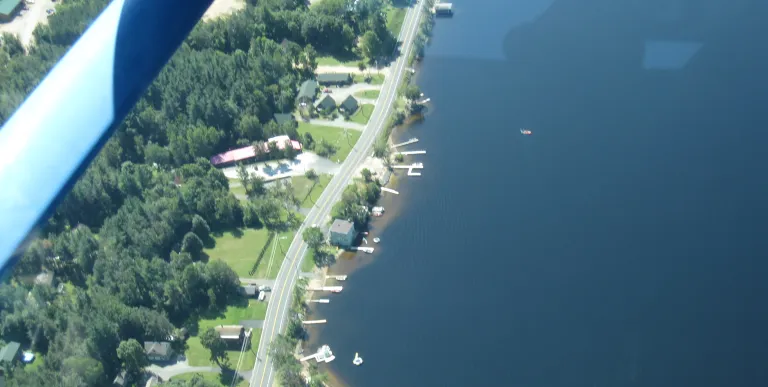 An aerial view of a road along the lake.