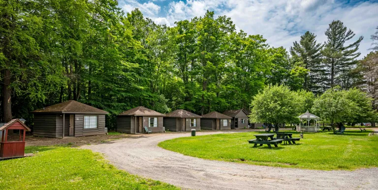 A round driveway to the small brown cabins.