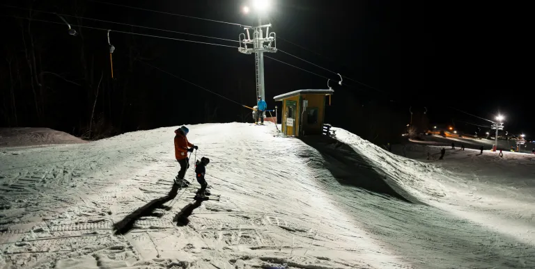 Skiers about to do a night run on Mt Pisgah