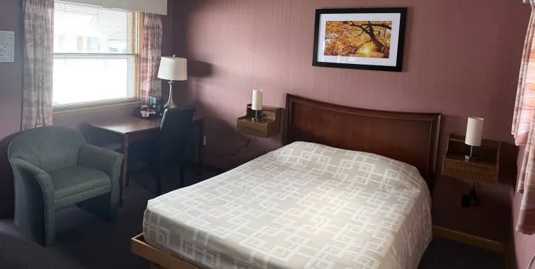  microwave and dresser and walls of knotty pine paneling at the Tupper Lake Motel