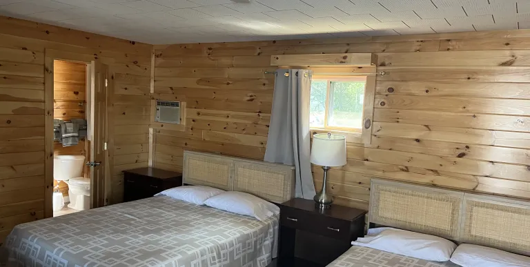 Looking in a a two bed room at The Tupper Lake Motel.